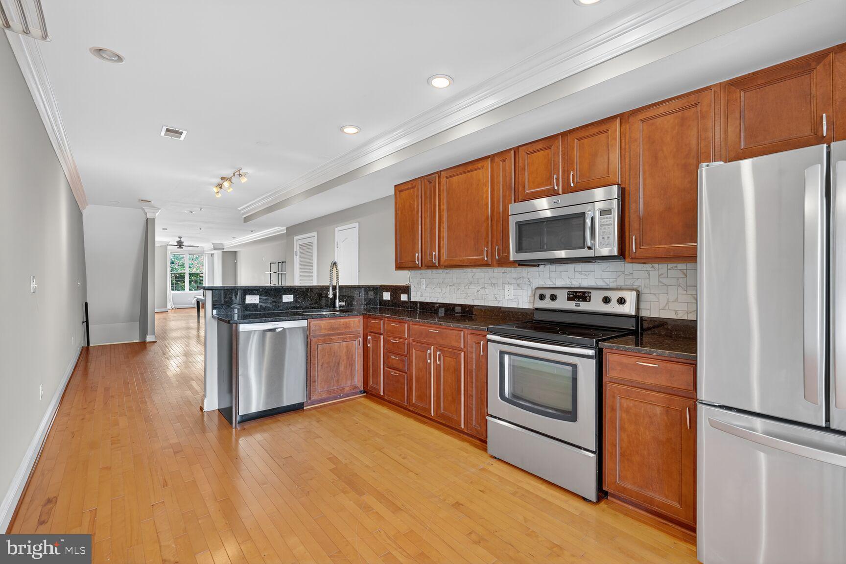 1730 1st Street Northwest, Unit 2 Washington, DC 20001 - Photo 10 of 27 a kitchen with stainless steel appliances granite countertop a refrigerator stove top oven and sink