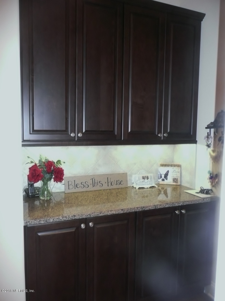 308 Mission Trace Drive St. Augustine, FL 32084 - Photo 11 of 20 a kitchen with granite countertop cabinets and utility
