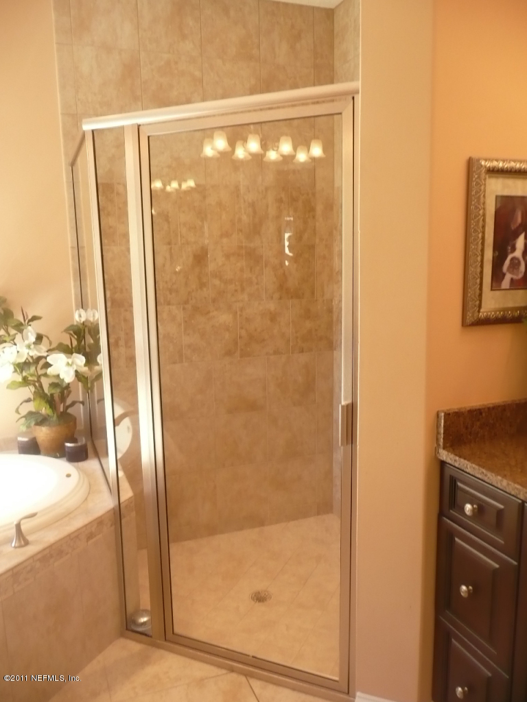 308 Mission Trace Drive St. Augustine, FL 32084 - Photo 15 of 20 a bathroom with a glass shower door