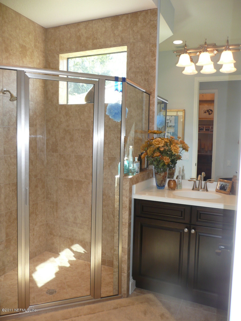 308 Mission Trace Drive St. Augustine, FL 32084 - Photo 17 of 20 a bathroom with a sink and a mirror