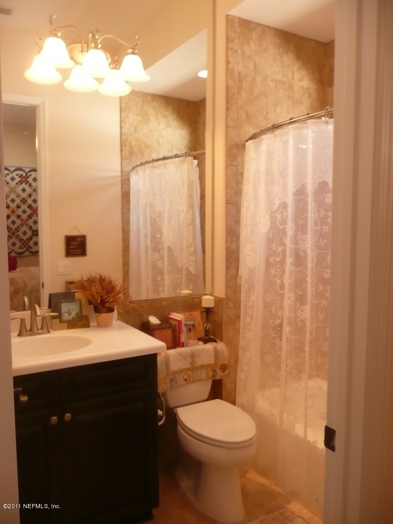 308 Mission Trace Drive St. Augustine, FL 32084 - Photo 19 of 20 a bathroom with a sink and a mirror