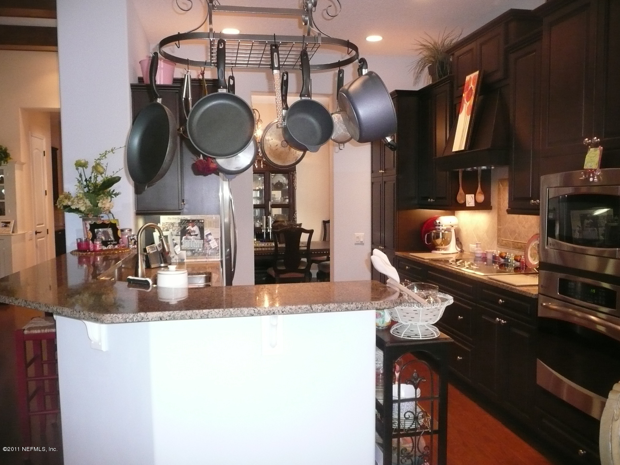 308 Mission Trace Drive St. Augustine, FL 32084 - Photo 7 of 20 a kitchen with stainless steel appliances granite countertop a sink a stove and a wooden cabinets