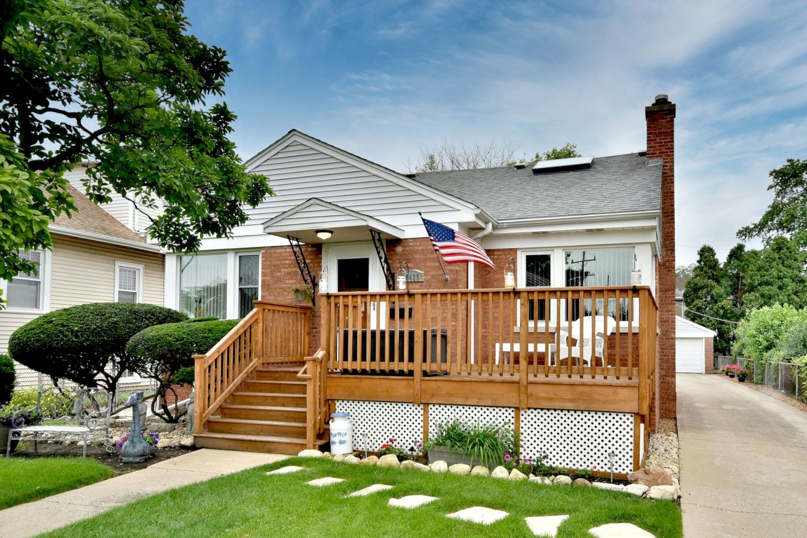 a view of a house with a yard and deck