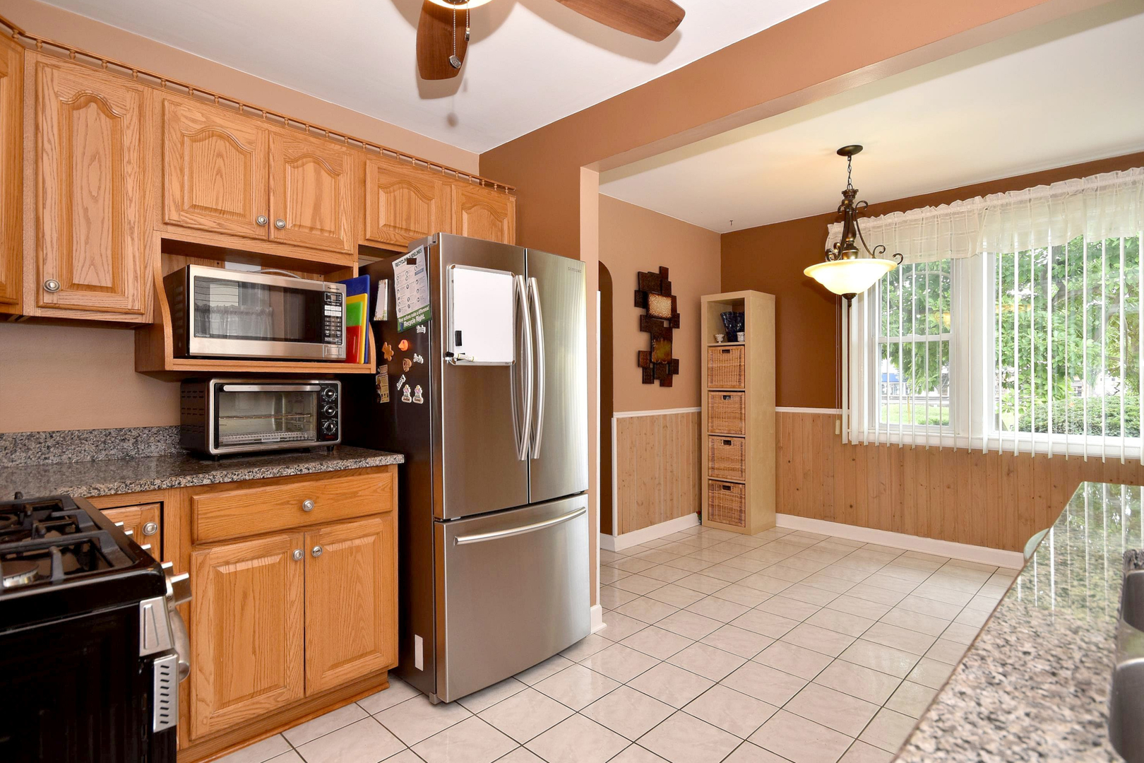 8423 Riverside Avenue Brookfield, IL 60513 - Photo 12 of 28 a kitchen with stainless steel appliances granite countertop a refrigerator a stove a sink dishwasher and a microwave oven