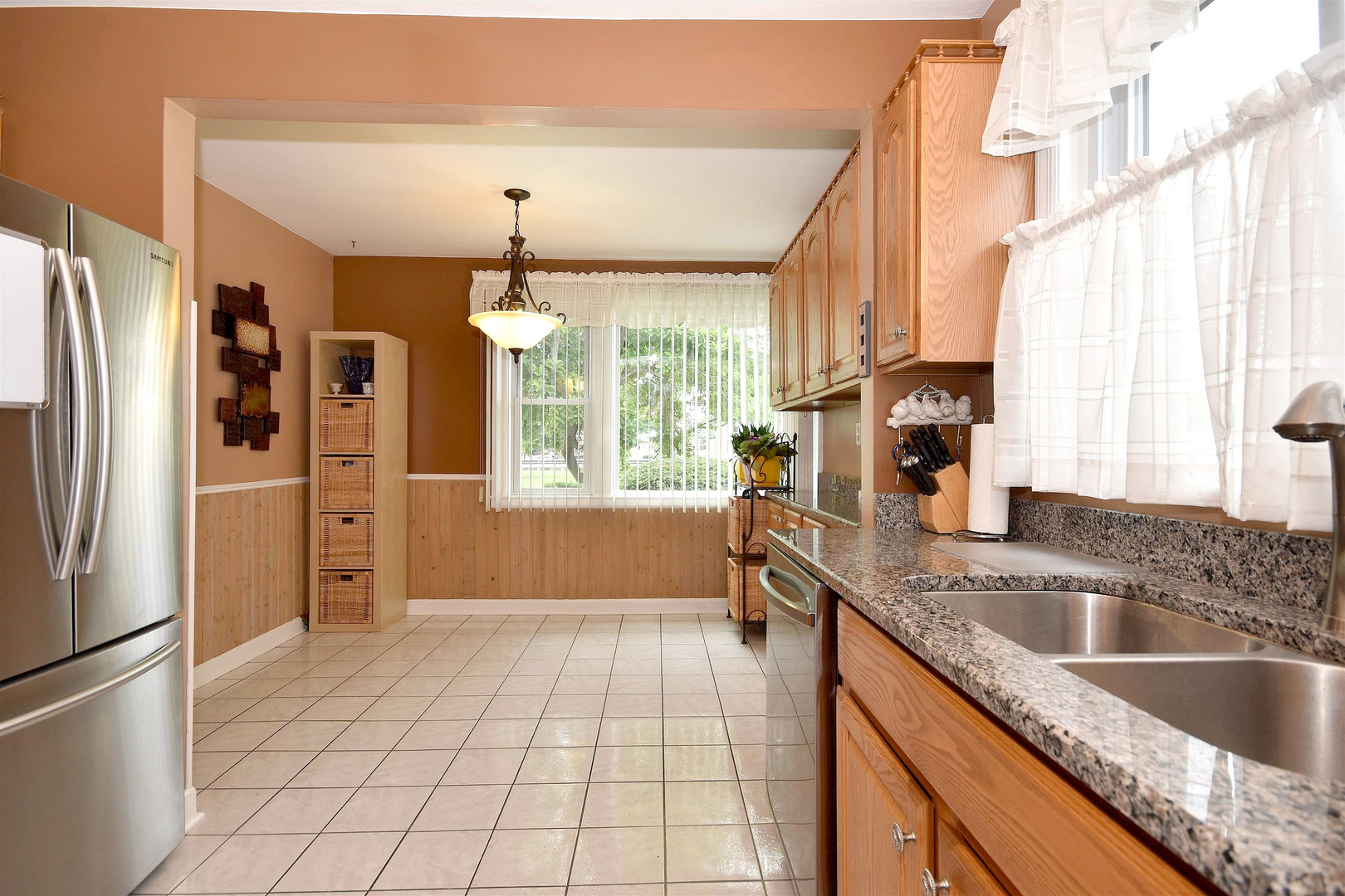 8423 Riverside Avenue Brookfield, IL 60513 - Photo 13 of 28 a kitchen with stainless steel appliances granite countertop a refrigerator a sink dishwasher with a countertop cabinets and wooden floor