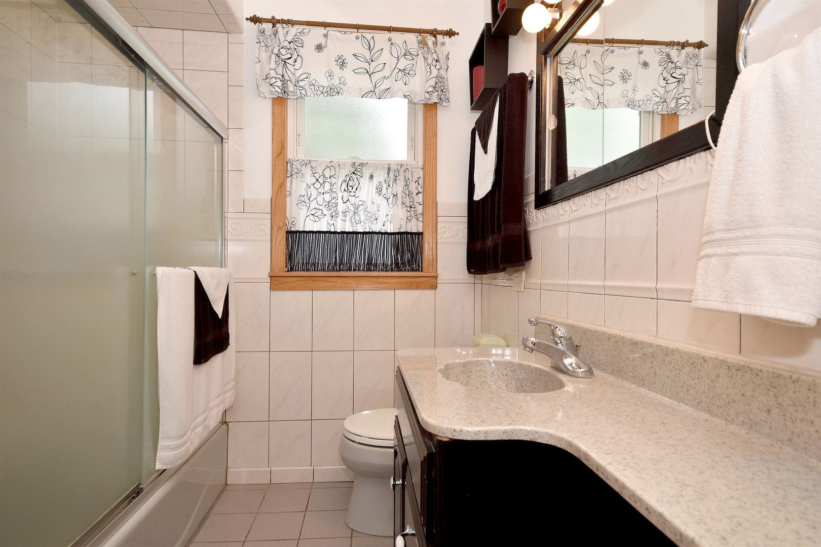 8423 Riverside Avenue Brookfield, IL 60513 - Photo 15 of 28 a bathroom with a sink vanity and a mirror