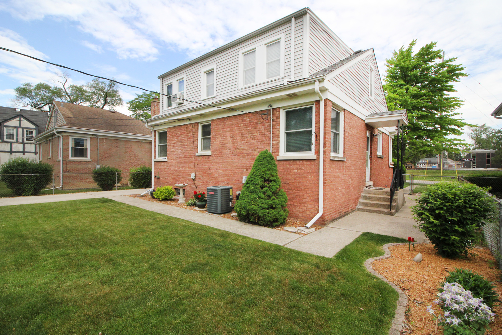 8423 Riverside Avenue Brookfield, IL 60513 - Photo 28 of 28 a front view of a house with a yard and potted plants