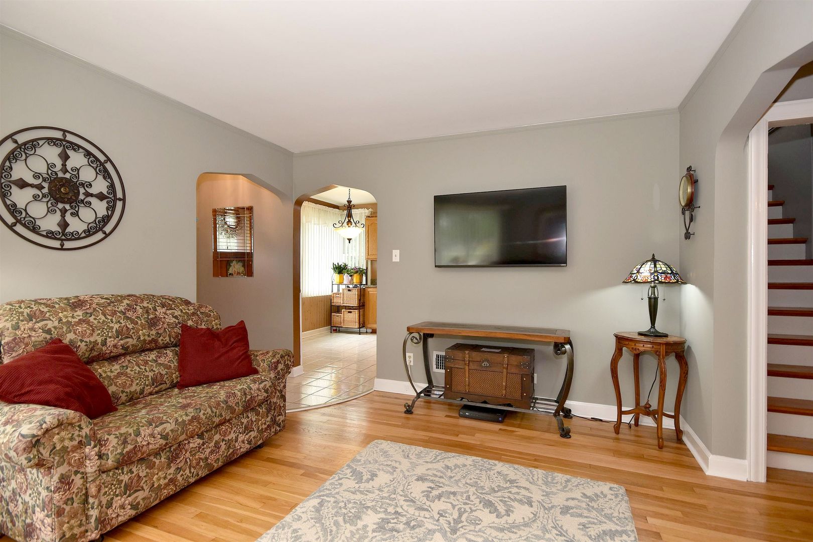 8423 Riverside Avenue Brookfield, IL 60513 - Photo 8 of 28 a living room with furniture a flat screen tv and a fireplace