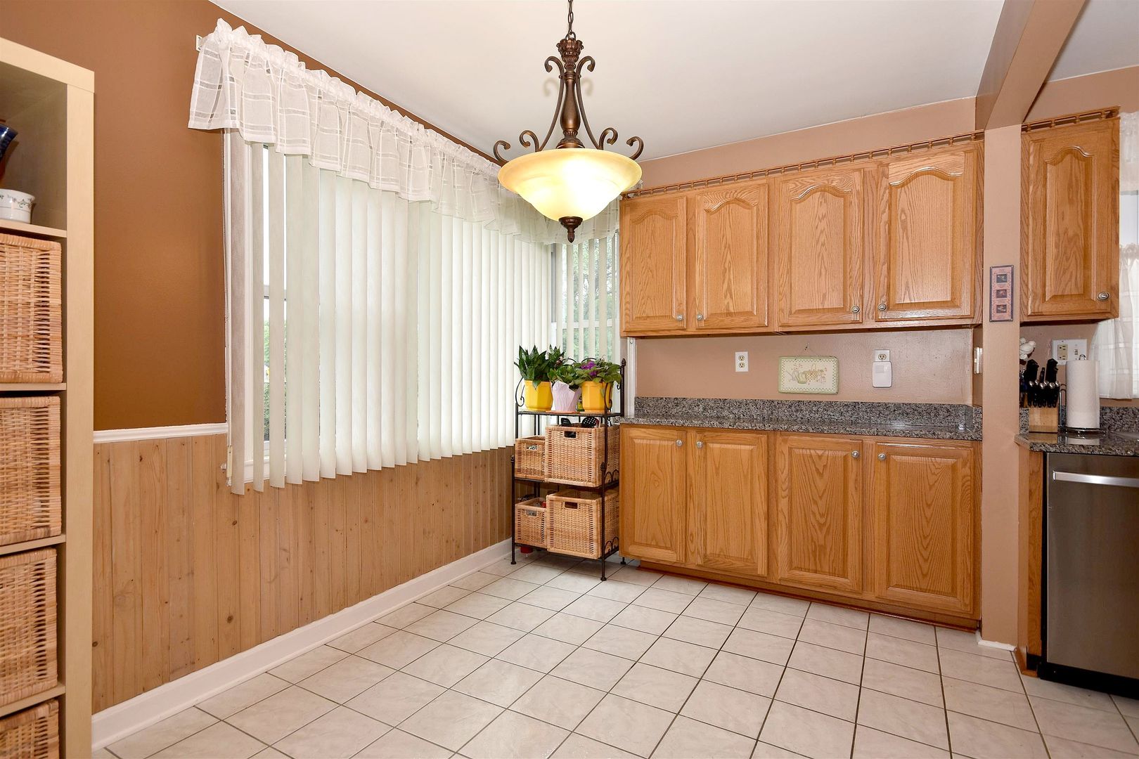 8423 Riverside Avenue Brookfield, IL 60513 - Photo 9 of 28 a kitchen with stainless steel appliances granite countertop a refrigerator and microwave