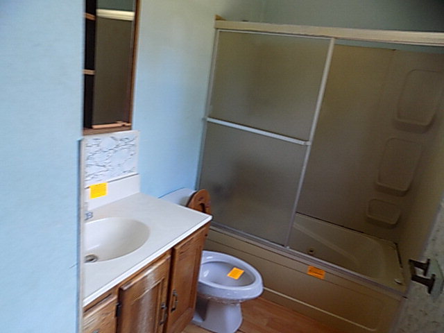 3294 South Lizella Road Lizella, GA 31052 - Photo 16 of 17 a bathroom with a sink a toilet and shower