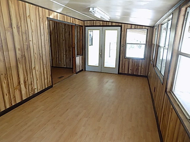 3294 South Lizella Road Lizella, GA 31052 - Photo 8 of 17 an empty room with wooden floor and windows