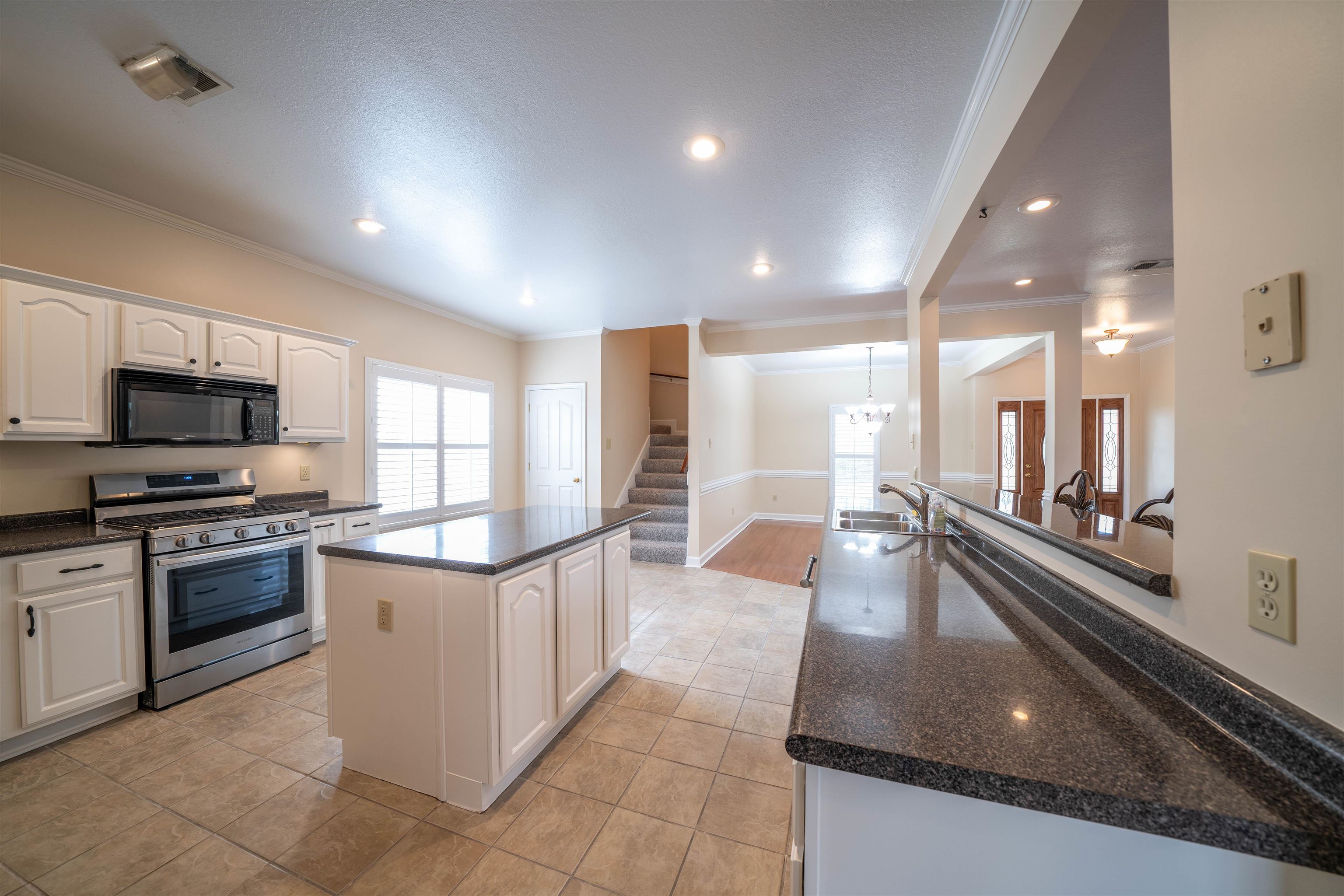 3740 Charles Bartlett Road Millington, TN 38053 - Photo 12 of 36 a large kitchen with stainless steel appliances granite countertop a large counter top and a stove top oven
