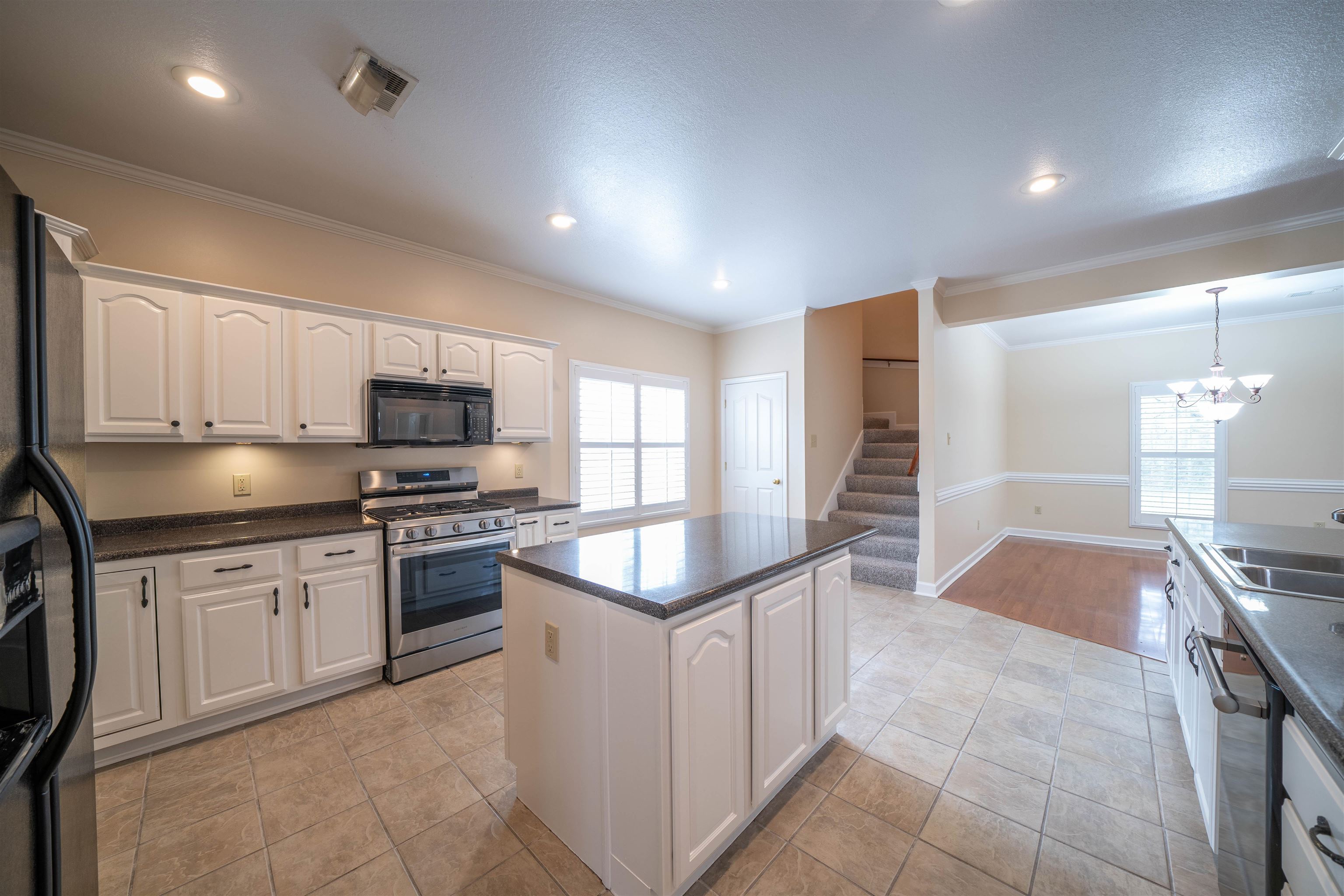 3740 Charles Bartlett Road Millington, TN 38053 - Photo 13 of 36 a kitchen with stainless steel appliances kitchen island granite countertop a stove a sink and a refrigerator