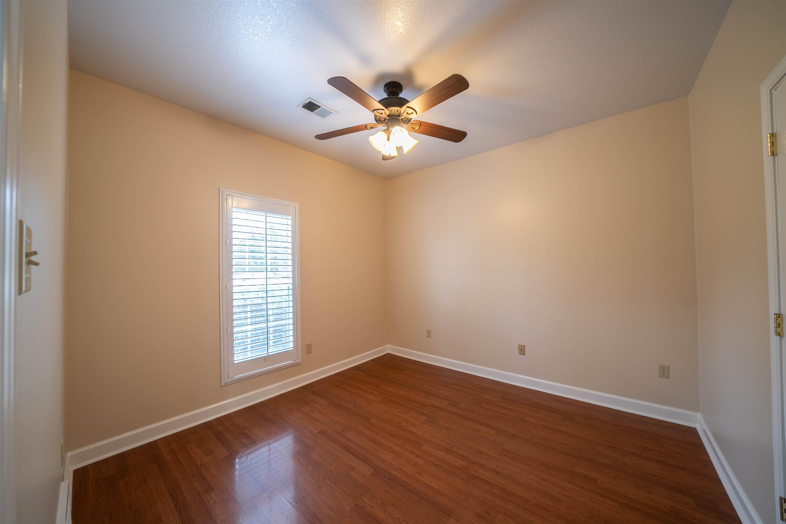 3740 Charles Bartlett Road Millington, TN 38053 - Photo 21 of 36 wooden floor in an empty room with a window