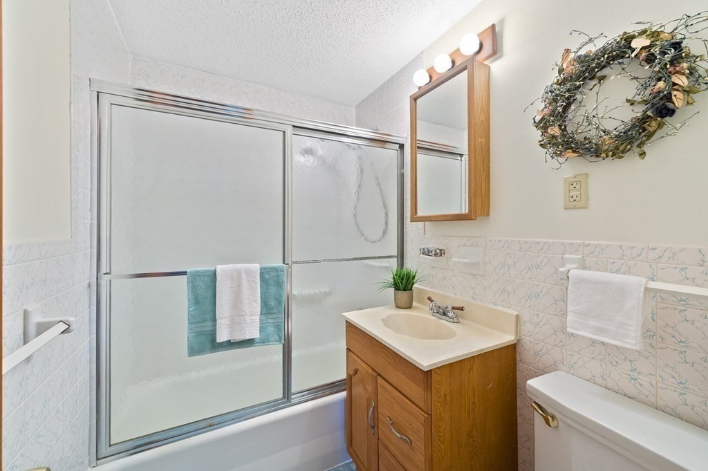 53 Merrill Road Springfield, MA 01119 - Photo 2 of 30 a bathroom with a sink and mirror with bathtub