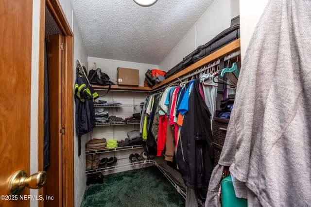 a kitchen with lots of counter top space dining table and stainless steel appliances