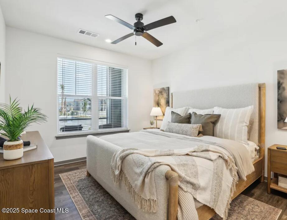 1073 Journey Circle, Unit 201 Rockledge, FL 32955 - Photo 4 of 10 a bedroom with bed and a potted plant