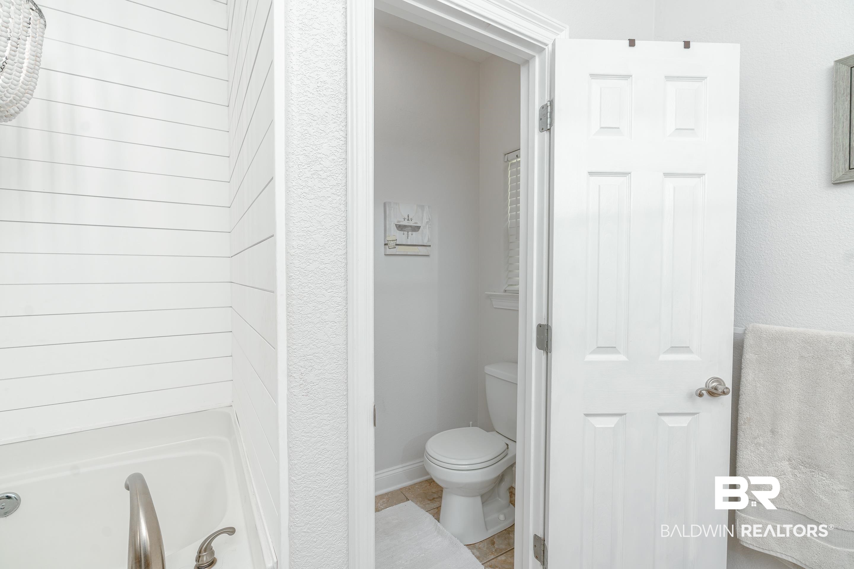 302 Bristol Way Foley, AL 36535 - Photo 20 of 51 Bathroom with a bathing tub, tile patterned flooring, and toilet