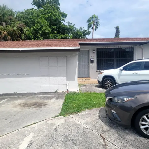 a view of a car parked front of a house