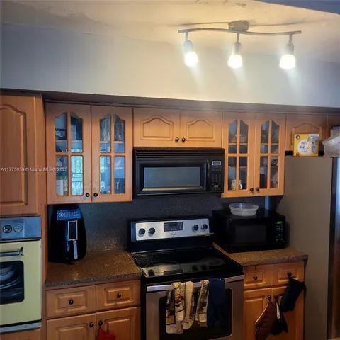 a kitchen with a stove and a microwave