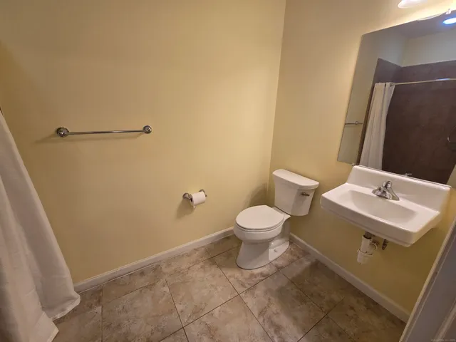 a white toilet sitting next to a bathroom sink