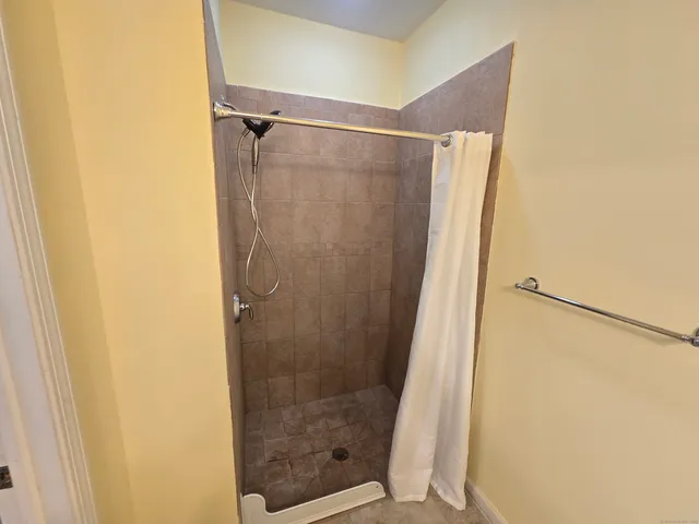 a bathroom with a glass door shower