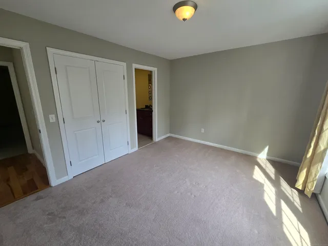 a view of an empty room and wooden floor