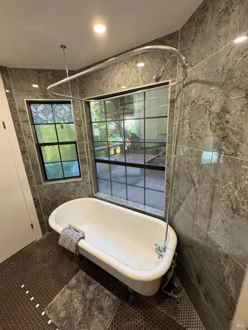 a bathroom with a bathtub and shower