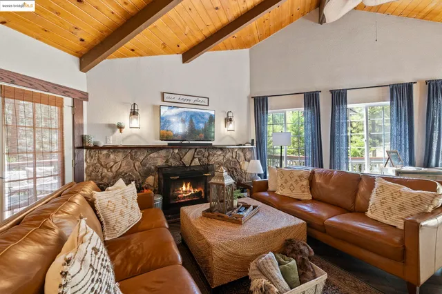 a bedroom with two beds and painting on the wall