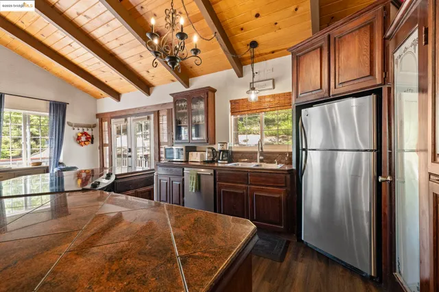 a spacious bedroom with a bed a table and wooden floor