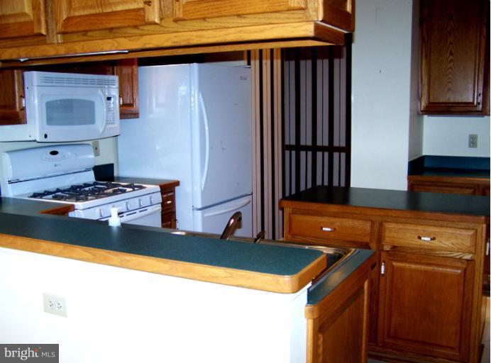 2373 Bear Den Road Frederick, MD 21701 - Photo 12 of 26 a kitchen with granite countertop a sink stove and refrigerator