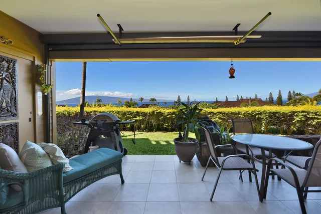 a living room with furniture a rug and a floor to ceiling window