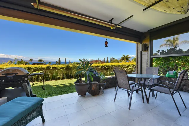 a view of an chairs and table in patio
