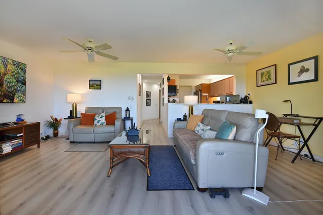 a living room with furniture and a wooden floor