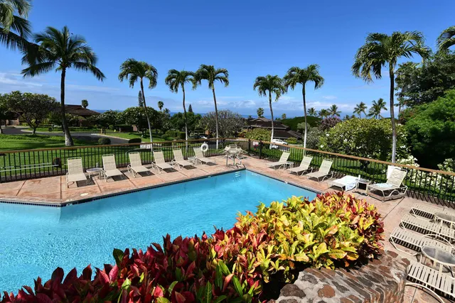 a view of a swimming pool with a table and chairs