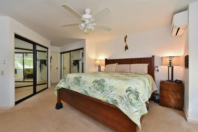 a spacious bedroom with a bed and a lamp