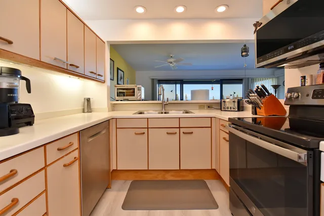 a kitchen with a sink cabinets and appliances