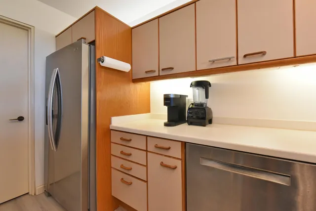 a kitchen with a refrigerator and cabinets