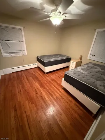 a view of room with wooden floor