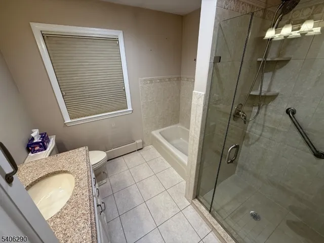 a bathroom with a granite countertop sink a mirror and shower