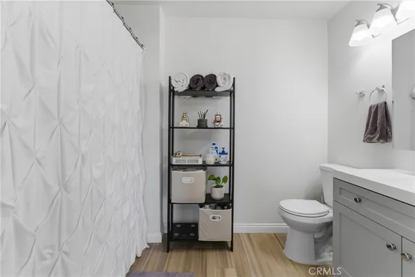 a bathroom with a toilet and a shower curtain