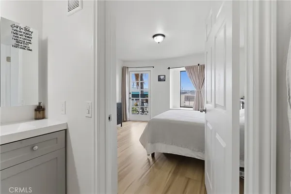 a bedroom with a bed and a large window