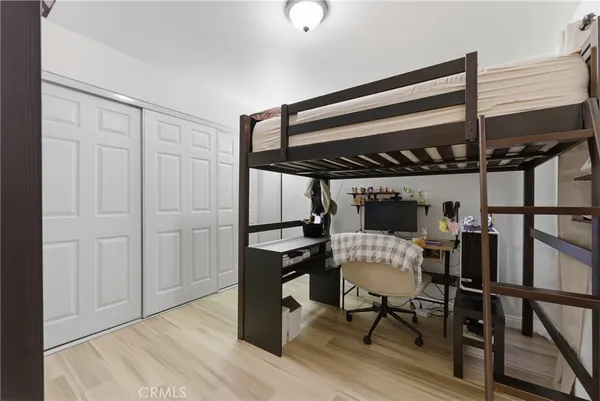 a bedroom with a bed a desk and chair
