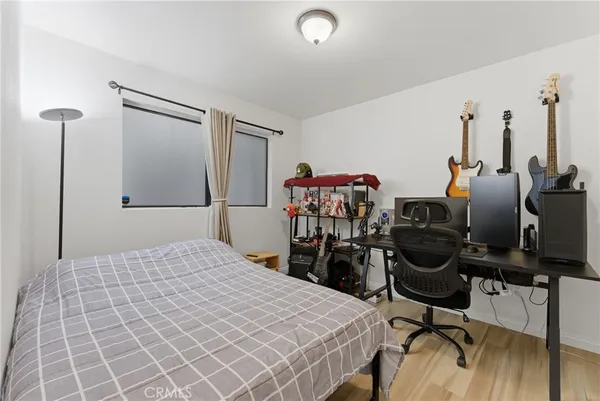 a view of a workspace with furniture and wooden floor