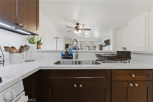 a kitchen with a sink a cabinets and appliances