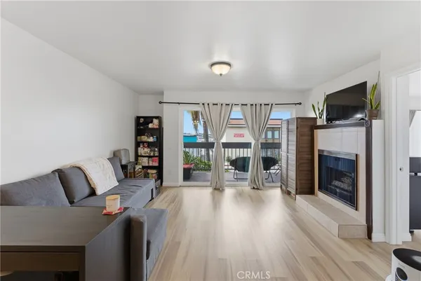 a living room with furniture a flat screen tv and a fireplace