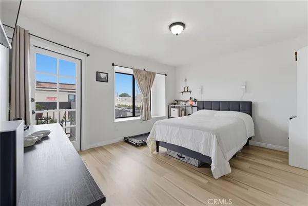 a spacious bedroom with a bed and a large window