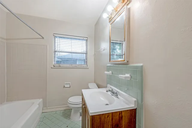 a bathroom with a sink toilet and bathtub