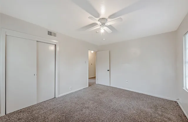 a view of an empty room with a fan