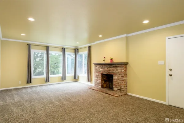 a view of an empty room with a fireplace